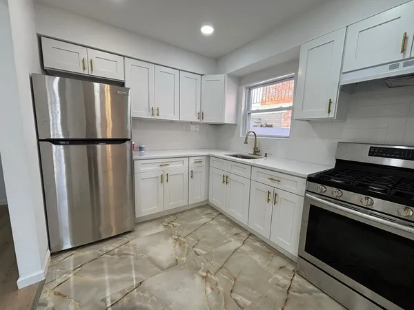 a kitchen with a white cabinets and white appliances