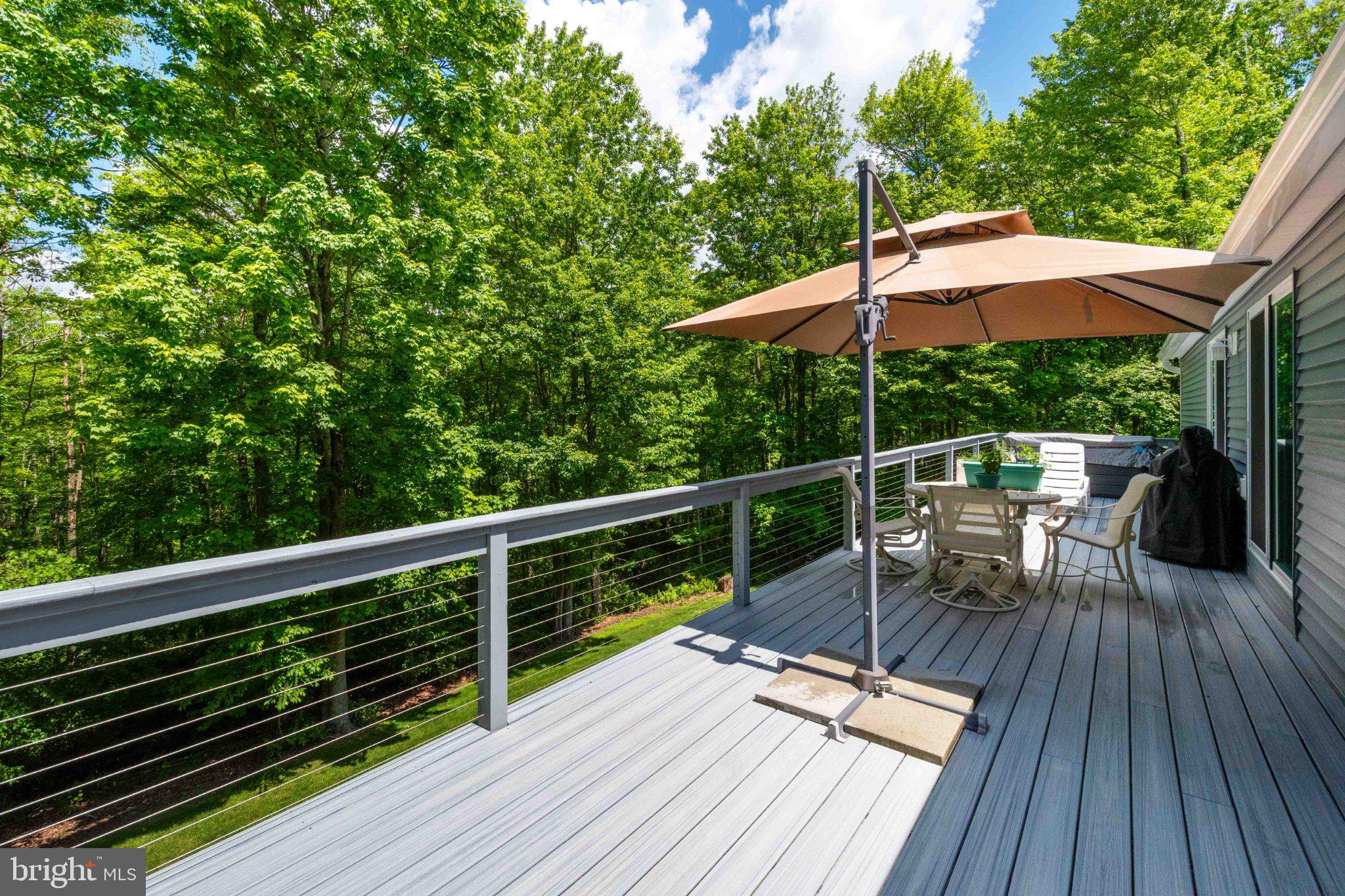 511 Hill Top Road Oakland, MD 21550 - Photo 50 of 51 Serene deck overlooking lush greenery.