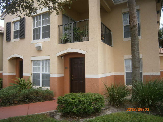 10312 Fox Trail Road South, Unit 1014 West Palm Beach, FL 33411 - Photo 1 of 12 a front view of a house with a yard
