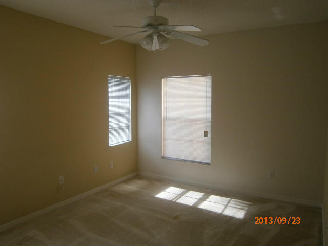 10312 Fox Trail Road South, Unit 1014 West Palm Beach, FL 33411 - Photo 12 of 12 an empty room with a window and a fan