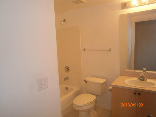 10312 Fox Trail Road South, Unit 1014 West Palm Beach, FL 33411 - Photo 4 of 12 a bathroom with a granite countertop toilet and a sink