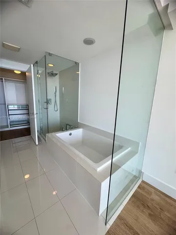 a bathroom with a shower and a sink