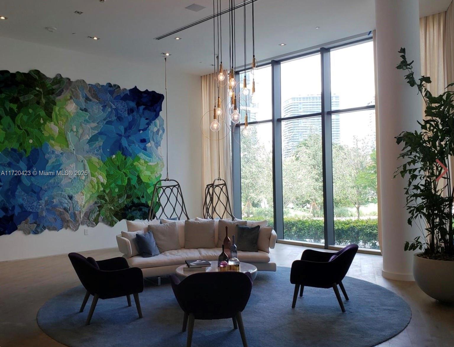 650 Northeast 32nd Street, Unit 1805 Miami, FL 33137 - Photo 19 of 21 a living room with furniture and a potted plant