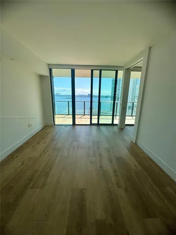 a view of an empty room with a window