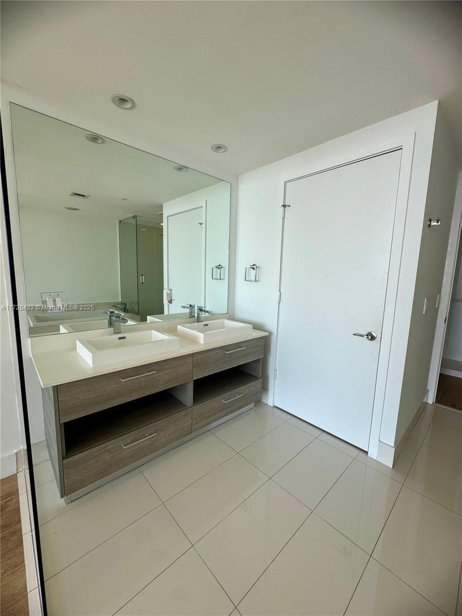 650 Northeast 32nd Street, Unit 1805 Miami, FL 33137 - Photo 9 of 21 a bathroom with a sink and a mirror