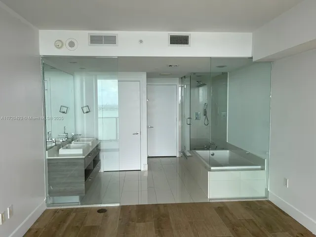 a bathroom with a tub and shower