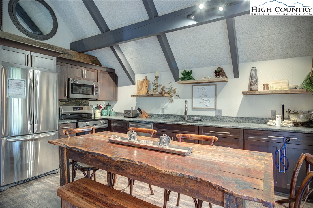 2950 Hickory Boone, NC 28607 - Photo 14 of 26 a kitchen with stainless steel appliances granite countertop a sink a stove and a refrigerator
