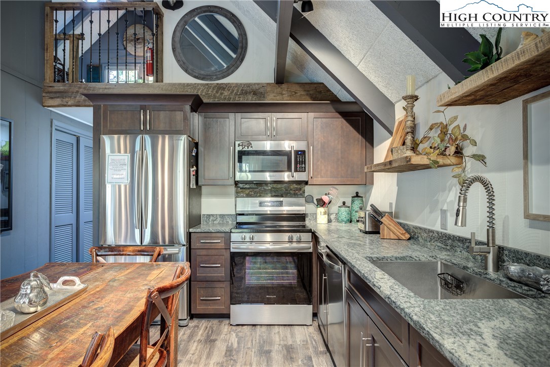 2950 Hickory Boone, NC 28607 - Photo 15 of 26 a kitchen with kitchen island granite countertop a sink and stove