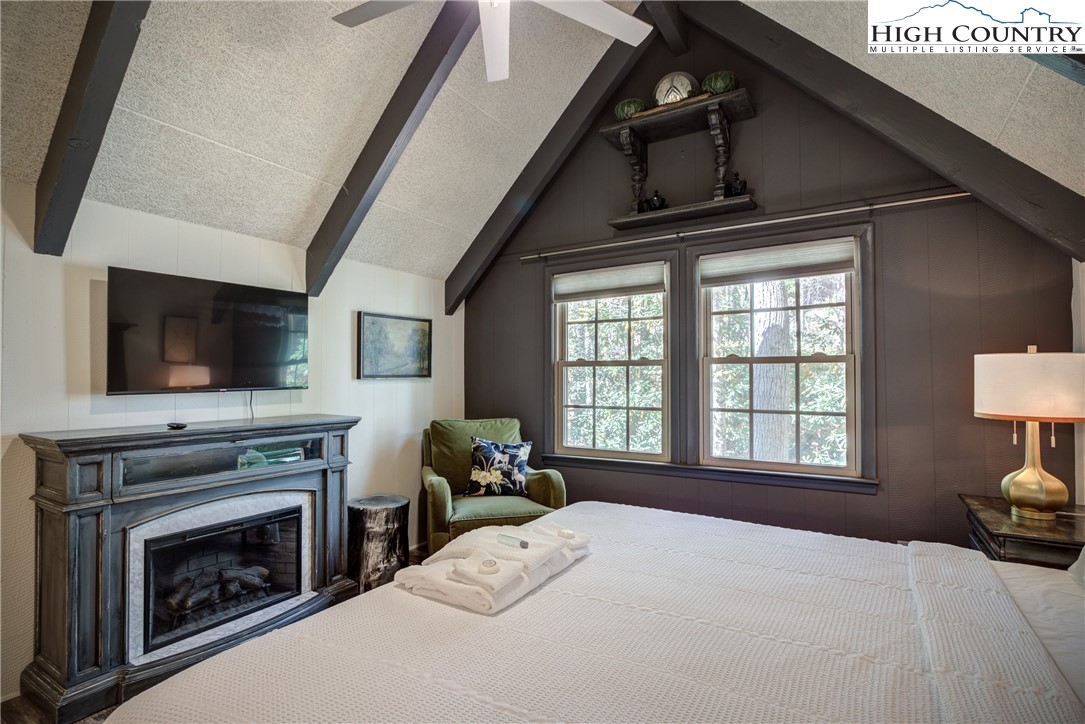 2950 Hickory Boone, NC 28607 - Photo 19 of 26 a bedroom with a bed a flat screen tv and a fireplace