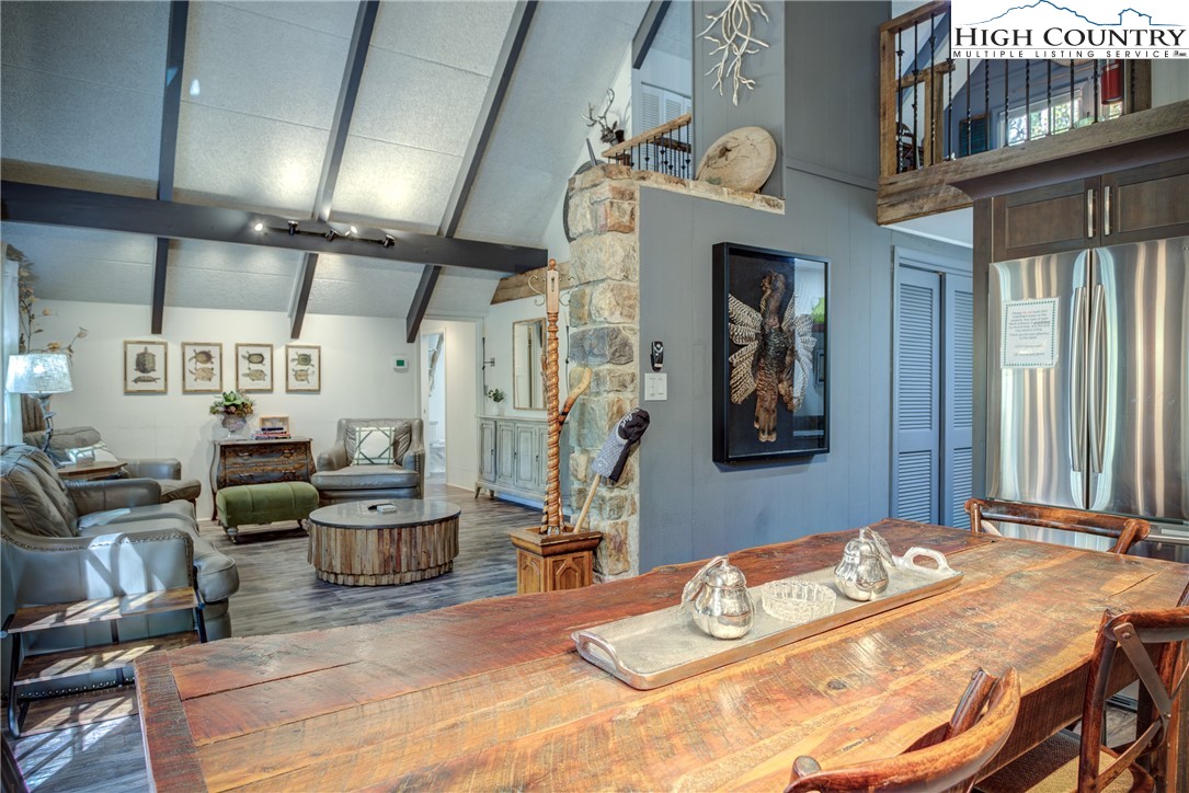 2950 Hickory Boone, NC 28607 - Photo 21 of 26 a bedroom with a bed a chandelier and flat screen tv