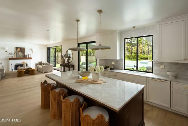 a kitchen with stainless steel appliances granite countertop a sink a stove and a wooden cabinets