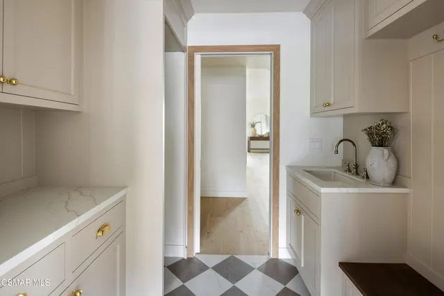 a spacious bathroom with a double vanity sink a mirror and a bathtub