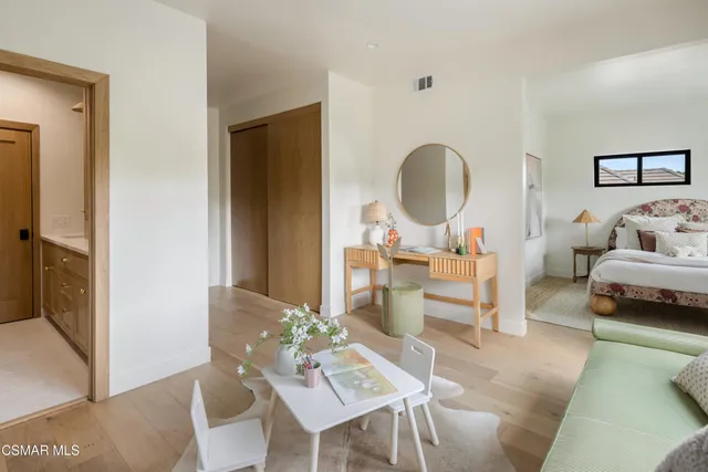 a view of a patio with a table chairs and a swimming pool