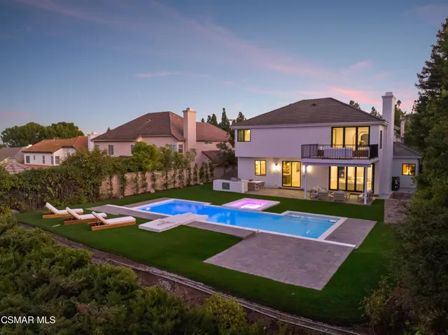 a view of swimming pool outdoor seating and city view