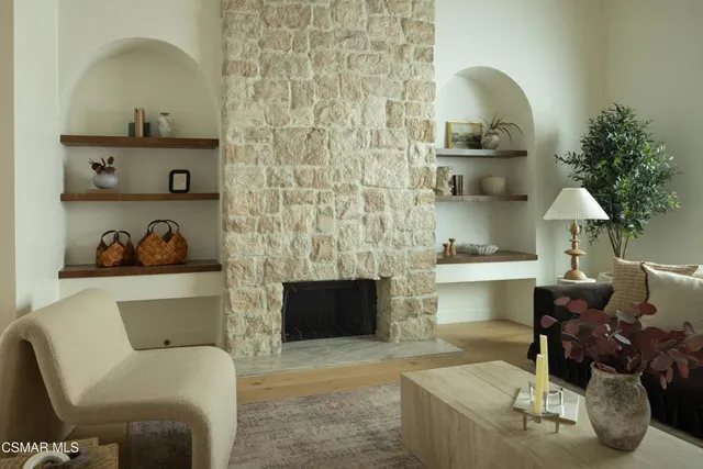 a living room with furniture and a fireplace