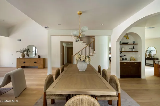 a room with furniture a chandelier and a window