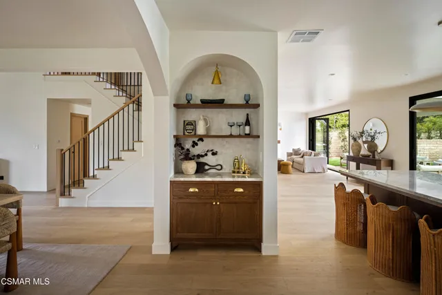 a kitchen with stainless steel appliances kitchen island granite countertop a refrigerator a stove and a sink