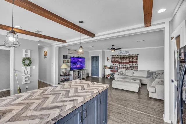 a view of living room kitchen and dining room