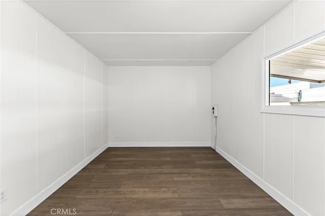 an empty room with wooden floor and closet