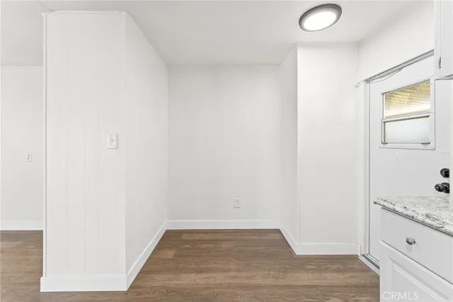 a view of a hallway with wooden floor