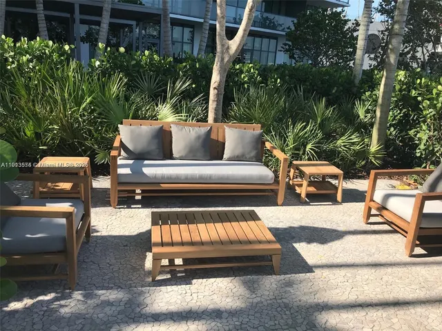 a view of a patio with couches chairs and a fire pit