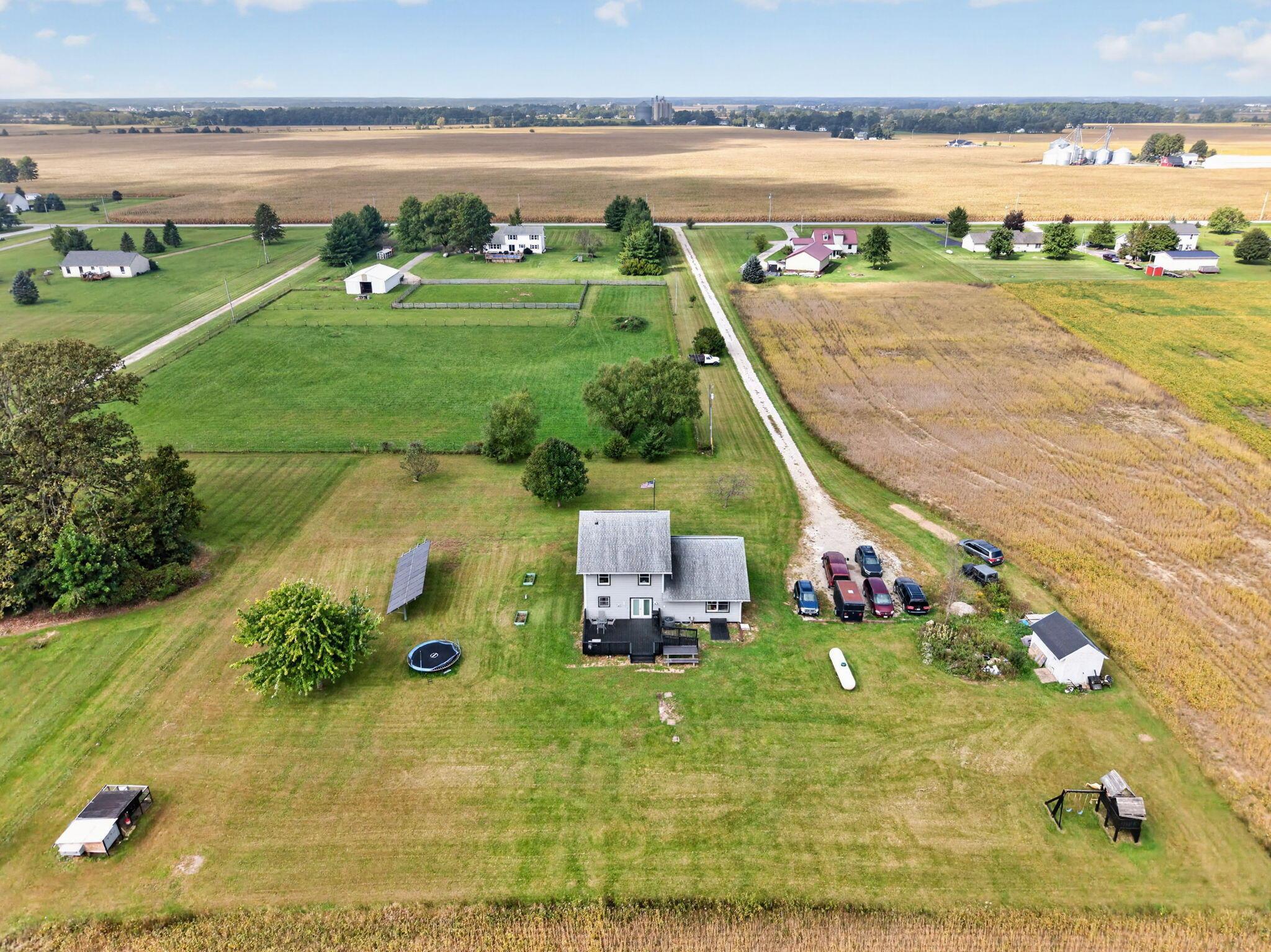 4780 North Section Line Road Radnor, OH 43066 - Photo 4 of 79 Expansive surrounding agricultural fields with multiple outbuildings, a gravel driveway, and solar panels