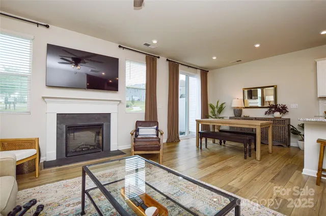 a living room with furniture fireplace and flat screen tv