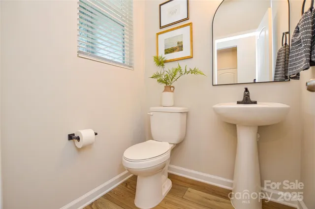 a bathroom with a sink toilet and a mirror