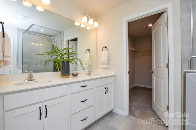 a bathroom with a double vanity sink and a mirror