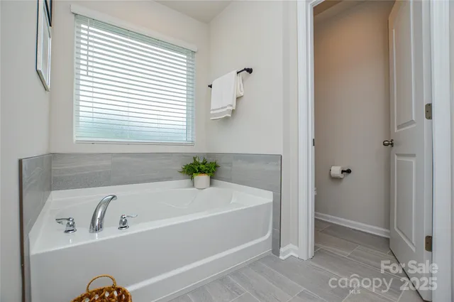 a bathroom with a bathtub and a window