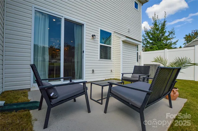 a view of a two chairs in the patio