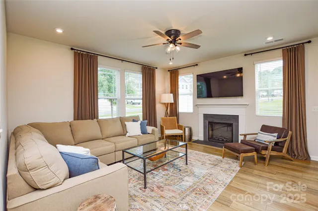 a living room with furniture fireplace and flat screen tv