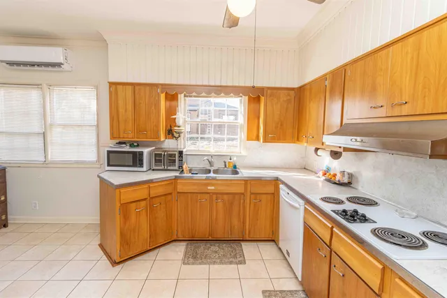 a kitchen with a sink a stove a refrigerator and cabinets