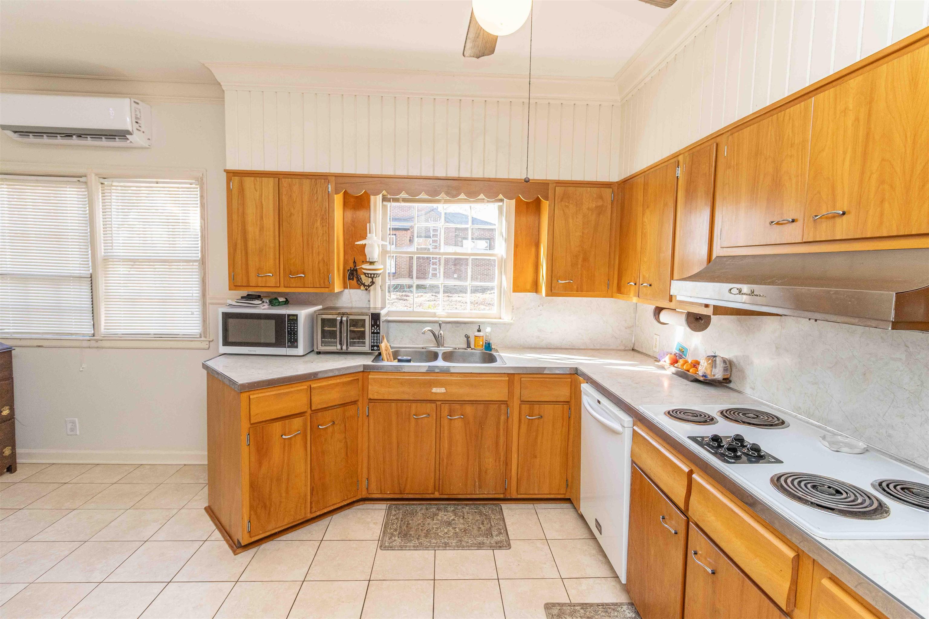 228 North 3rd Street Selmer, TN 38375 - Photo 11 of 33 a kitchen with a sink a stove a refrigerator and cabinets
