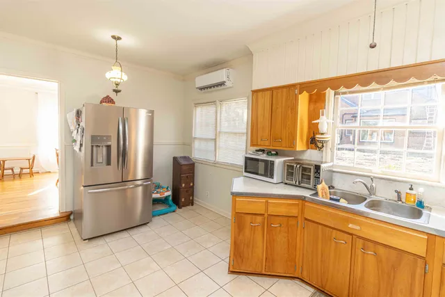a kitchen with stainless steel appliances granite countertop a refrigerator and a sink