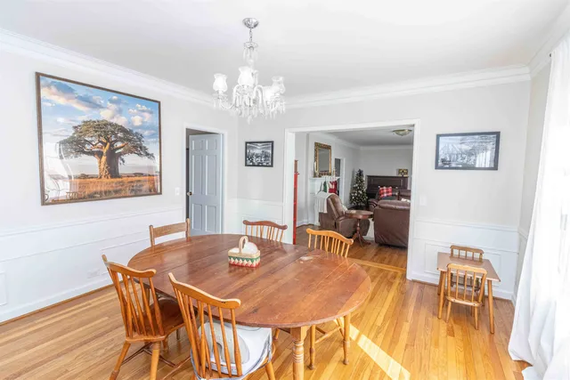 a view of a dining room with furniture and chandelier