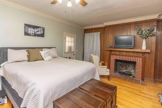 a bedroom with a bed and a fireplace