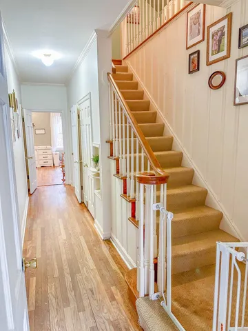 a view of an entryway with wooden floor