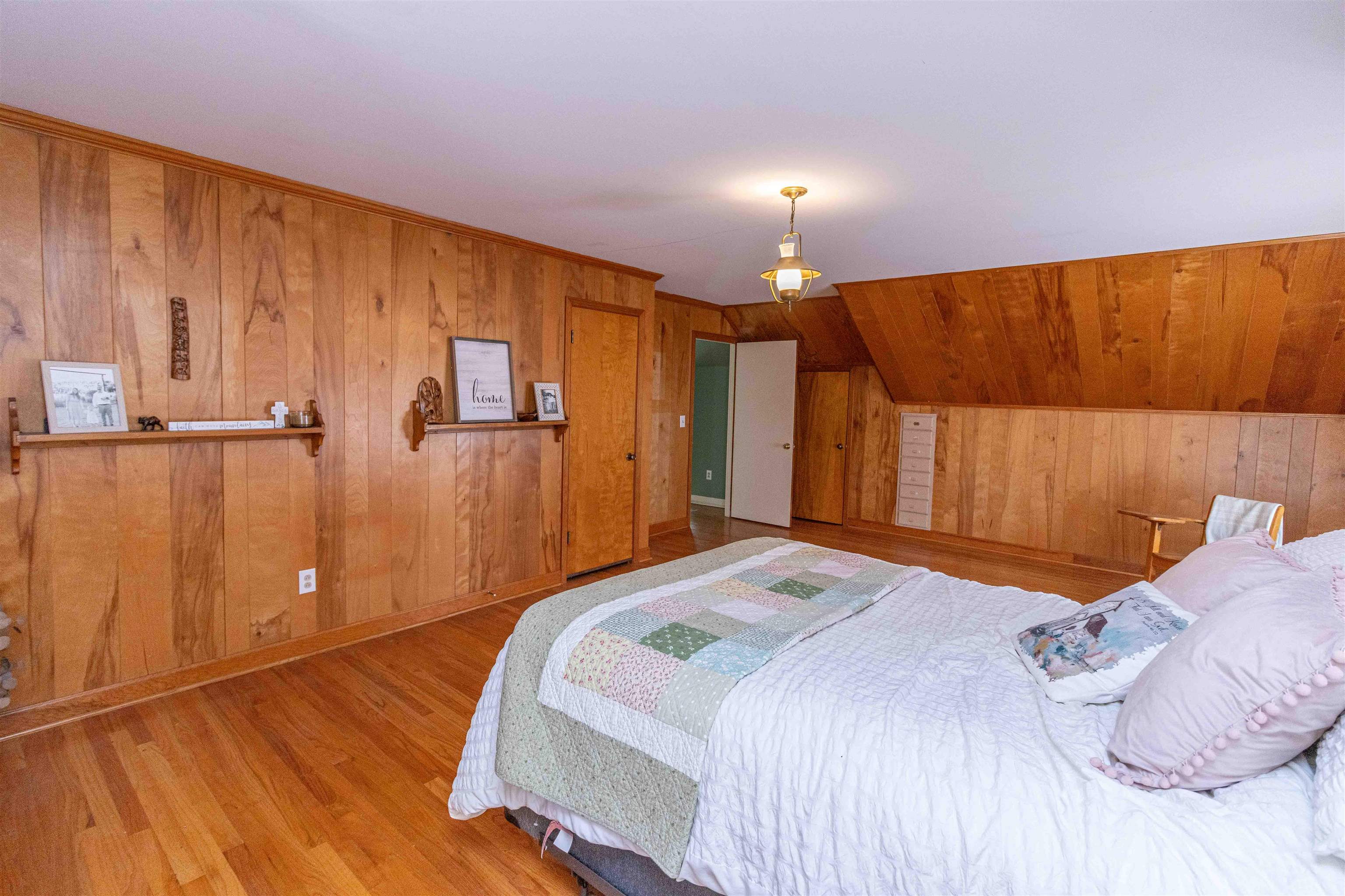 228 North 3rd Street Selmer, TN 38375 - Photo 23 of 33 a bedroom with a bed and a lamp with wooden floor