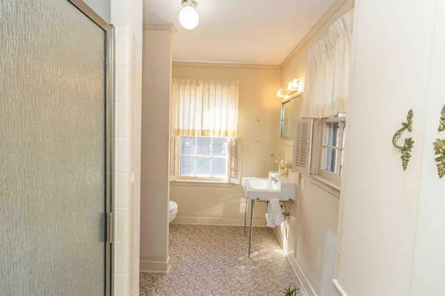 a bathroom with a tub sink and mirror