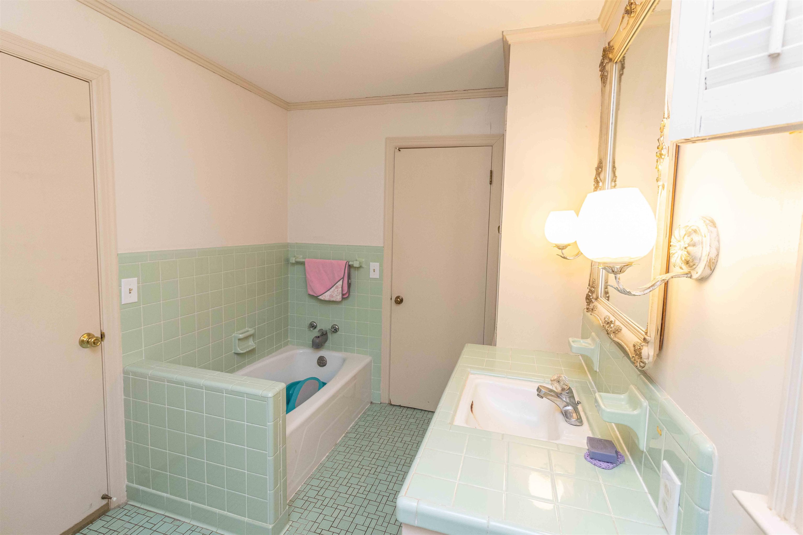 228 North 3rd Street Selmer, TN 38375 - Photo 28 of 33 a bathroom with a tub sink and mirror
