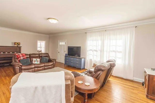 a bedroom with furniture and a flat screen tv
