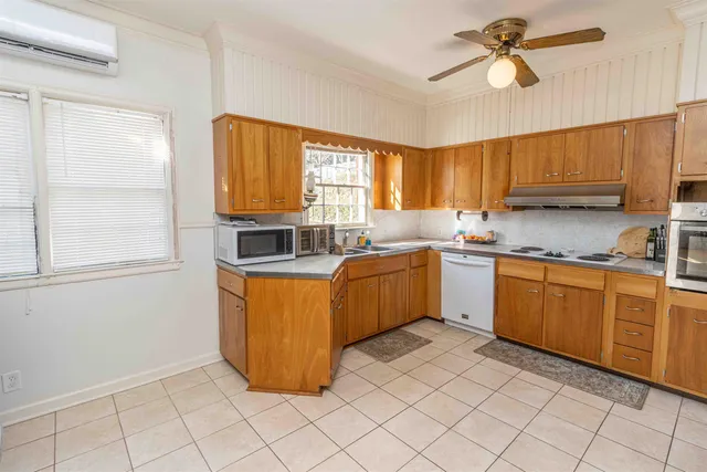 a kitchen with a sink window and cabinets