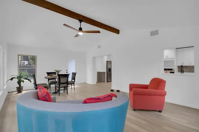 a living room with furniture and kitchen view