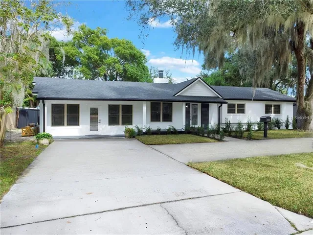 a front view of a house with yard patio and green space