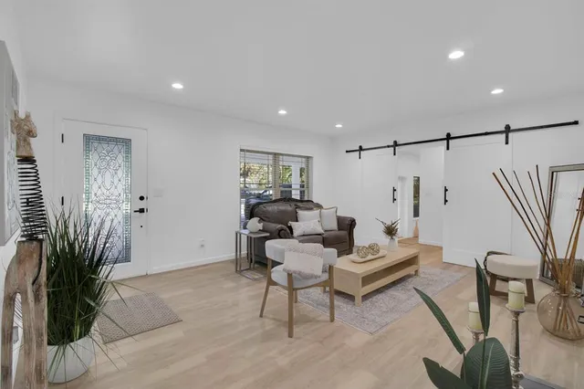 a living room with furniture and a potted plant