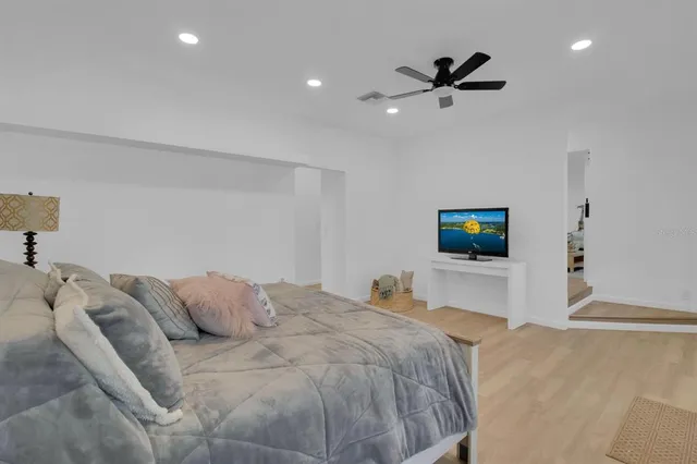 a bedroom with a bed and a tv