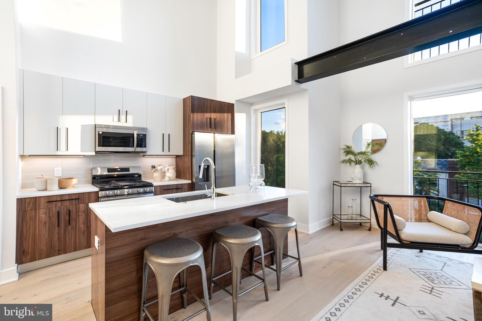 845 19th Street Northeast, Unit PH10 Washington, DC 20002 - Photo 5 of 21 a dining room with furniture wooden floor and a kitchen view
