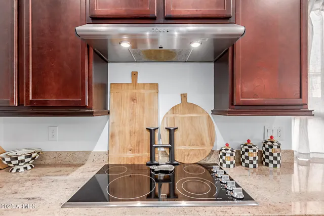a kitchen with a sink and a stove with wooden floor