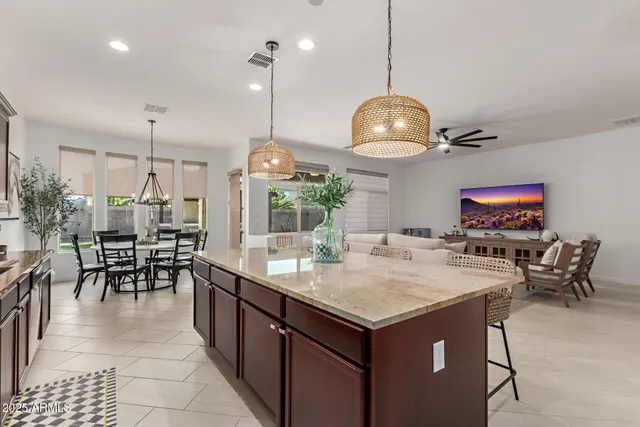 a kitchen with granite countertop a table and chairs in it